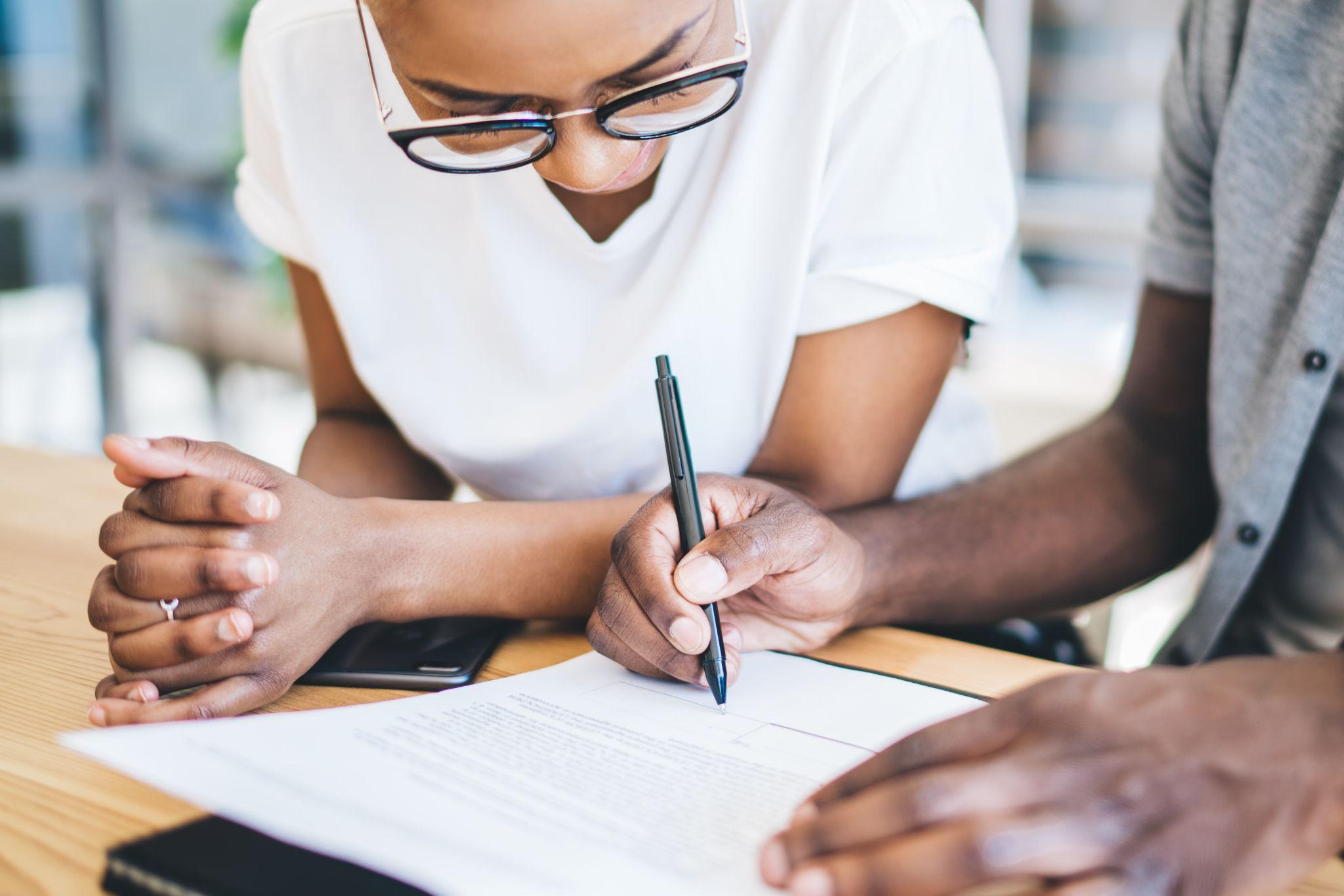 First-time home buyer signing mortgage documents
